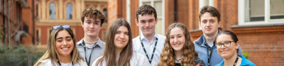 Young people stood at the Royal Geographical Society with the Royal Albert Hall in the background