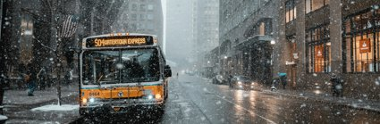 A bus on a street with snow falling