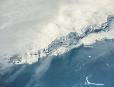 Snow covered mountain and ice shelf