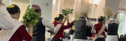 People in Indigenous Himalayan clothing doing a dance for an audience.