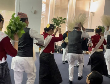 People in Indigenous Himalayan clothing doing a dance for an audience.