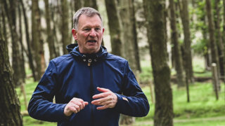 Martin Murphy in a forest wearing athletic wear.