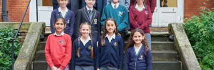 A selection of students who have won the Young Geographer of the Year competition standing on the steps of the Royal Geographical Society