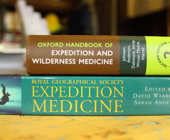 One book lays on top of another, and both are about expidition medicine.