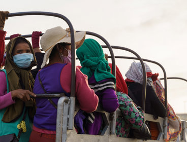 Women sitting in the back of a truck