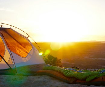 Camping tent on cliff at dusk