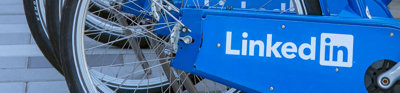 Close up of a row of blue byclies with the LinkedIn logo printed on the chain guard.