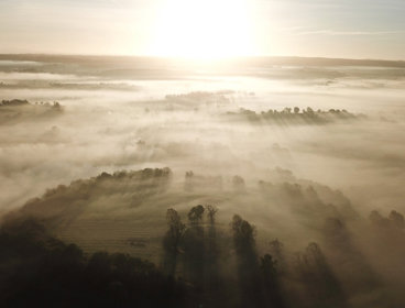 Fog surrounding Emain Macha, an Iron Age structure in Ireland.