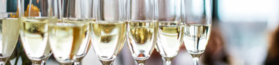 Select focus of glasses of champagne and sparkling wine served on a tray.