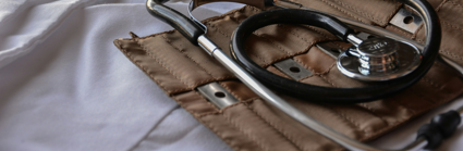 A stethoscope lays on its brown leather holder