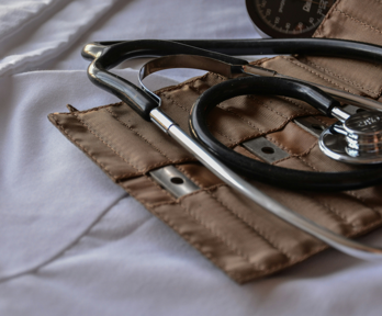 A stethoscope lays on its brown leather holder