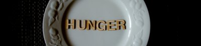 Whoite plate with the word hunger on