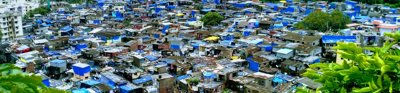 An aerial view over an informal settlement at the edge of a city