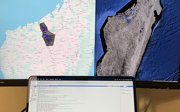 Two monitor screens showing an example of Google Earth Engine geospational analysis software.