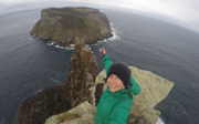 Phoebe Smith taking selfie on the edge of island.