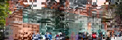 Exterior of the Royal Geographical Society Pavilion and main entrance, with people walking up to the entrance