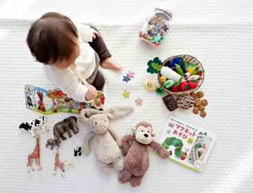 Child surrounded by toys