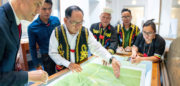 Society’s Director with representatives of the Penan communities, looking at Penan Community Maps