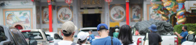 People in front of a Chinese temple.