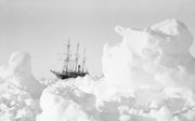 Old black and white photograph of the Endurance ship stuck in ice.