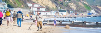 People on a beach walking and playing