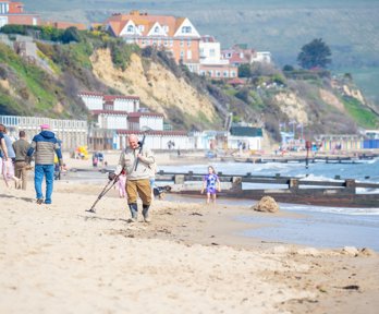 People on a beach walking and playing