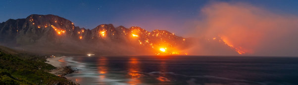 A 30-second exposure of a wildfire burning in the mountains of the Kogel Bay Nature Reserve at night.