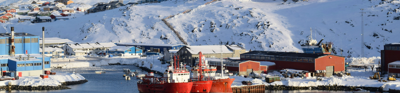 Ships dock at a mountainous artic port village in Sermitsiaq mountain, Nuuk