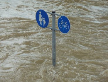 Rising flood water with road sign