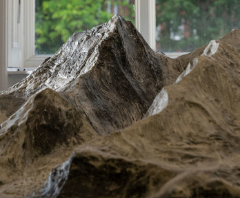 Close up of a mountain peak on a detailed plaster scale model of Mount Everest. 