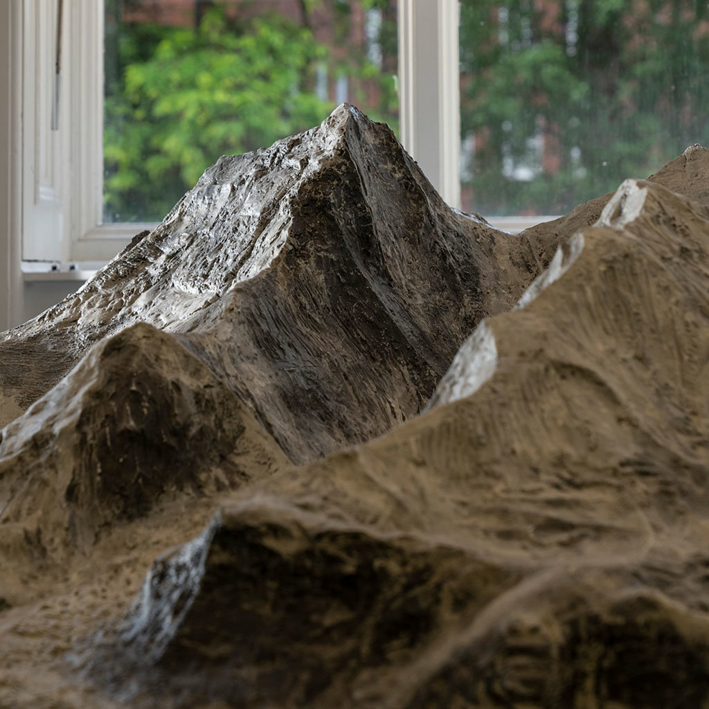 Close up of a mountain peak on a detailed plaster scale model of Mount Everest. 