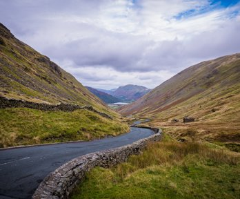 A widning road through a valley in the Lake District
