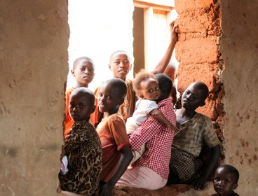 A group of African children sitting in a window opening