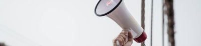 Arm holding a loud hailer