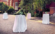 Poseur tables with flowers setup on the terrace for an evening drinks reception.