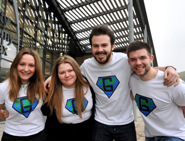 Group of people posing for a photo with their arms around each other's shoulders.