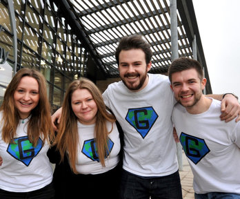 Group of people posing for a photo with their arms around each other's shoulders.