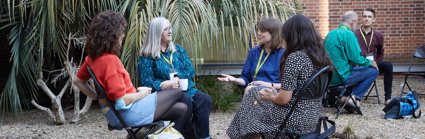 Four female conference delegates seated and having a conversation