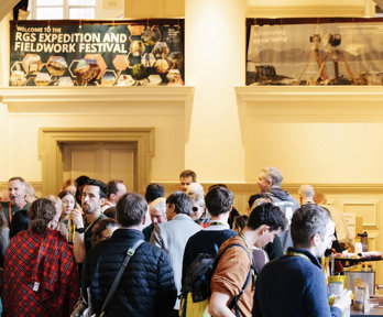 Explore symposium attendees gather in the Main Hall of the Royal Geographical Society to browse the exhibitors' stands.