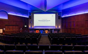 The Ondaatje Theatre at the Society with a screen that says welcome to the Royal Geographical Society.