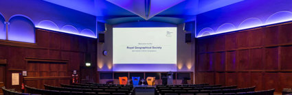 The Ondaatje Theatre at the Society with a screen that says welcome to the Royal Geographical Society.