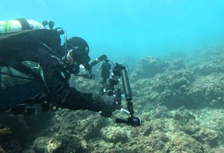 Driver using underwater camera to capture 3D scans of a coral reef.