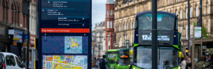 Sign with map and green bus in town centre