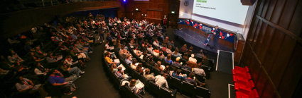 RGS Director Joe Smith welcomes attendees in the Ondaatje Theatre during the Explore 2024 opening address.