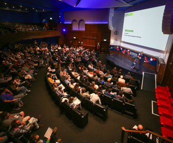 RGS Director Joe Smith welcomes attendees in the Ondaatje Theatre during the Explore 2024 opening address.