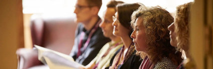 Conference delegates listening attentively to a presentation.