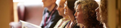 Conference delegates listening attentively to a presentation.