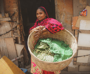 A woman holding prodcue in a basket