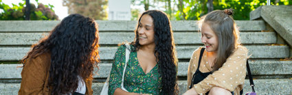 People sitting on stone steps whilst chatting