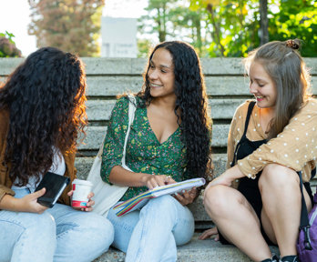 People sitting on stone steps whilst chatting